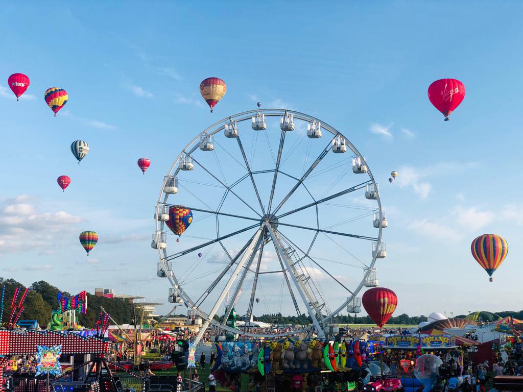 Ferris wheel and hot air balloons at a funfair